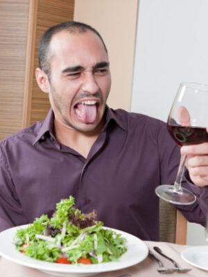 young-male-holding-up-a-glass-of-bad-wine-picture-id185088079